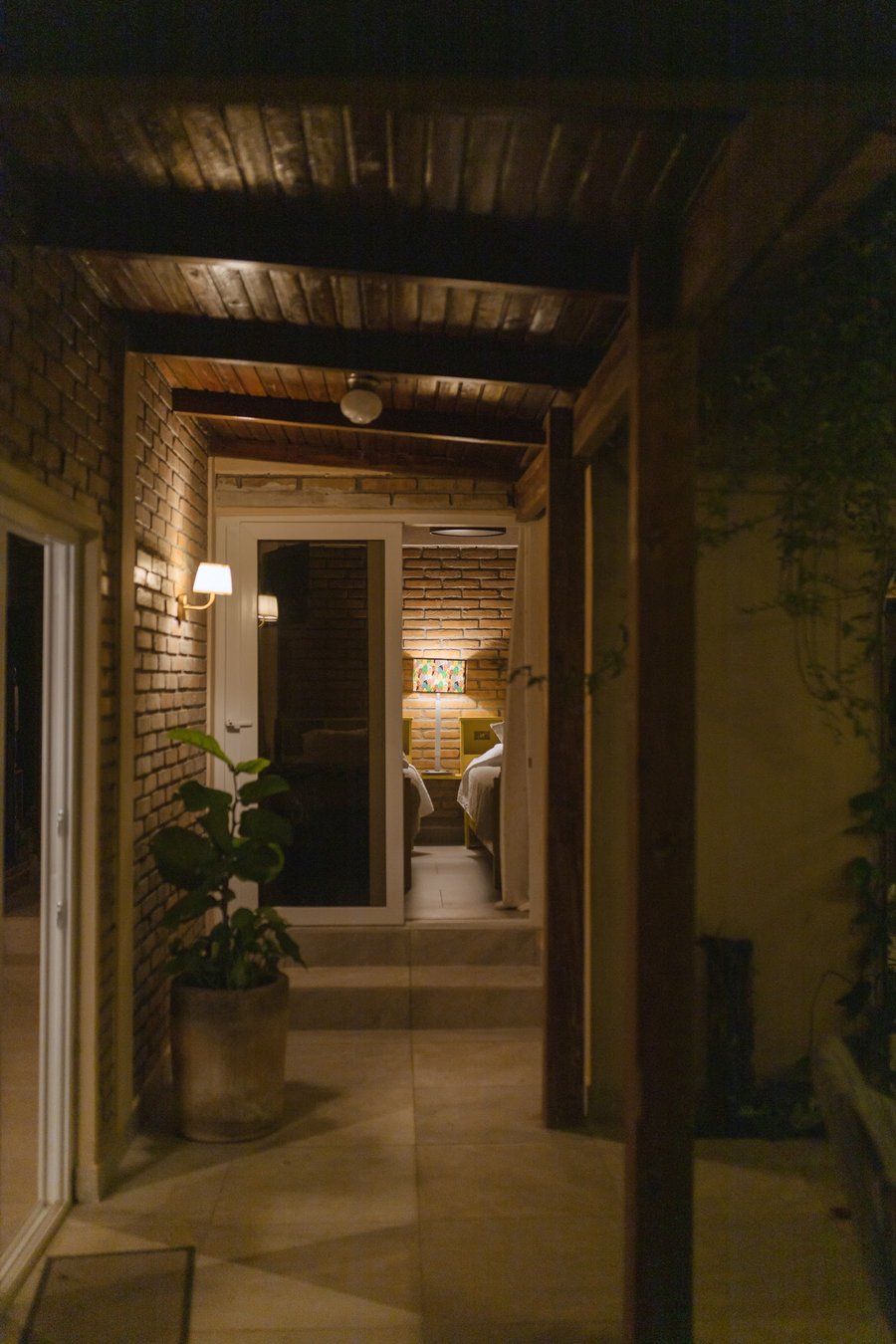 El corredor de ladrillo de noche, con los apliques encendidos